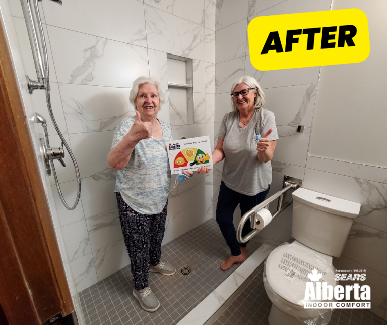 Two homeowners in their newly remodelled accessible bathroom, with a grab bar beside the toilet
