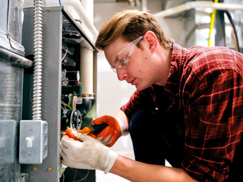 Calgary furnace maintenance technician performing fire safety tune-up Calgary furnace maintenance technician performing fire safety tune-up