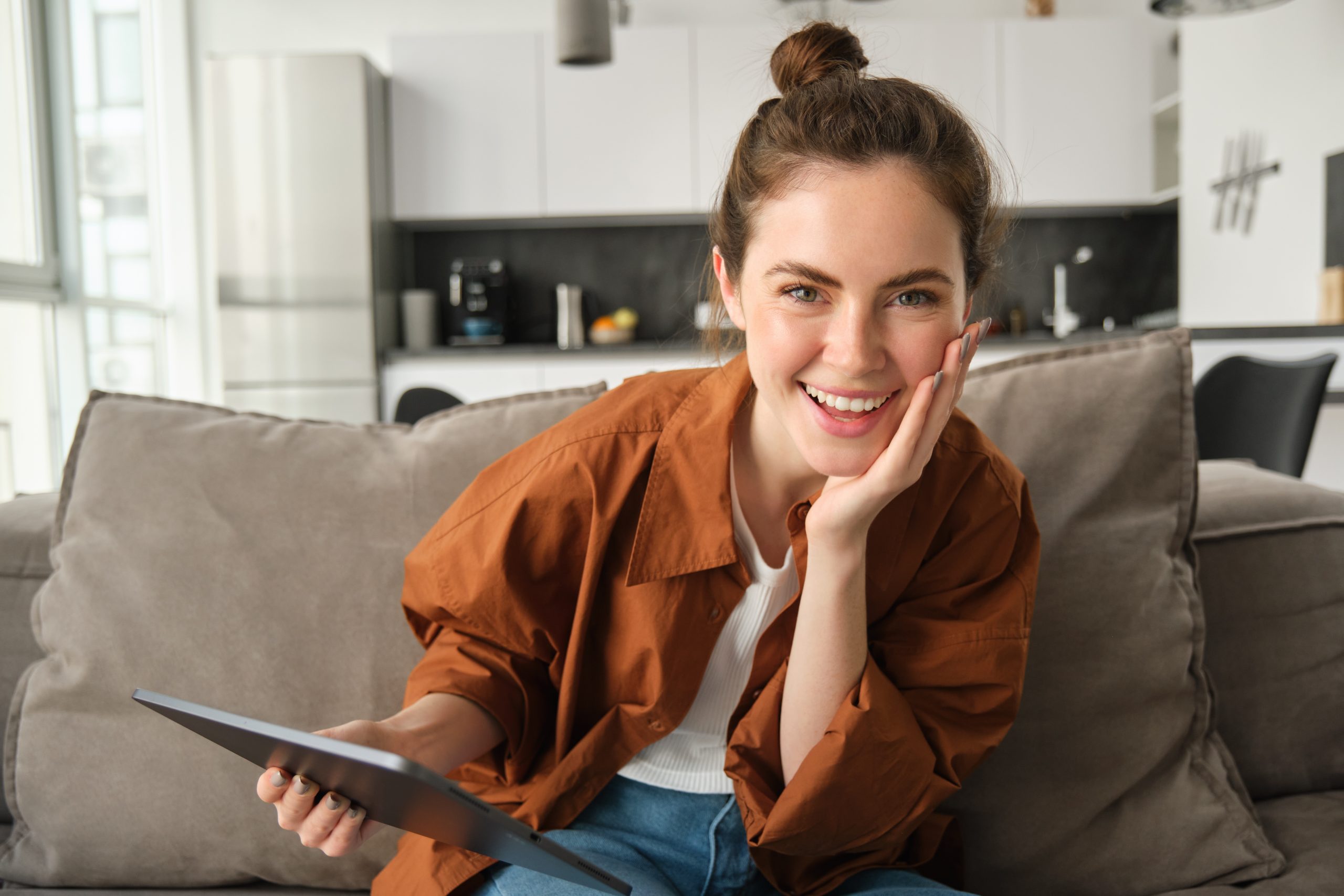 Woman relaxing on the couch in a comfortably heated Calgary home