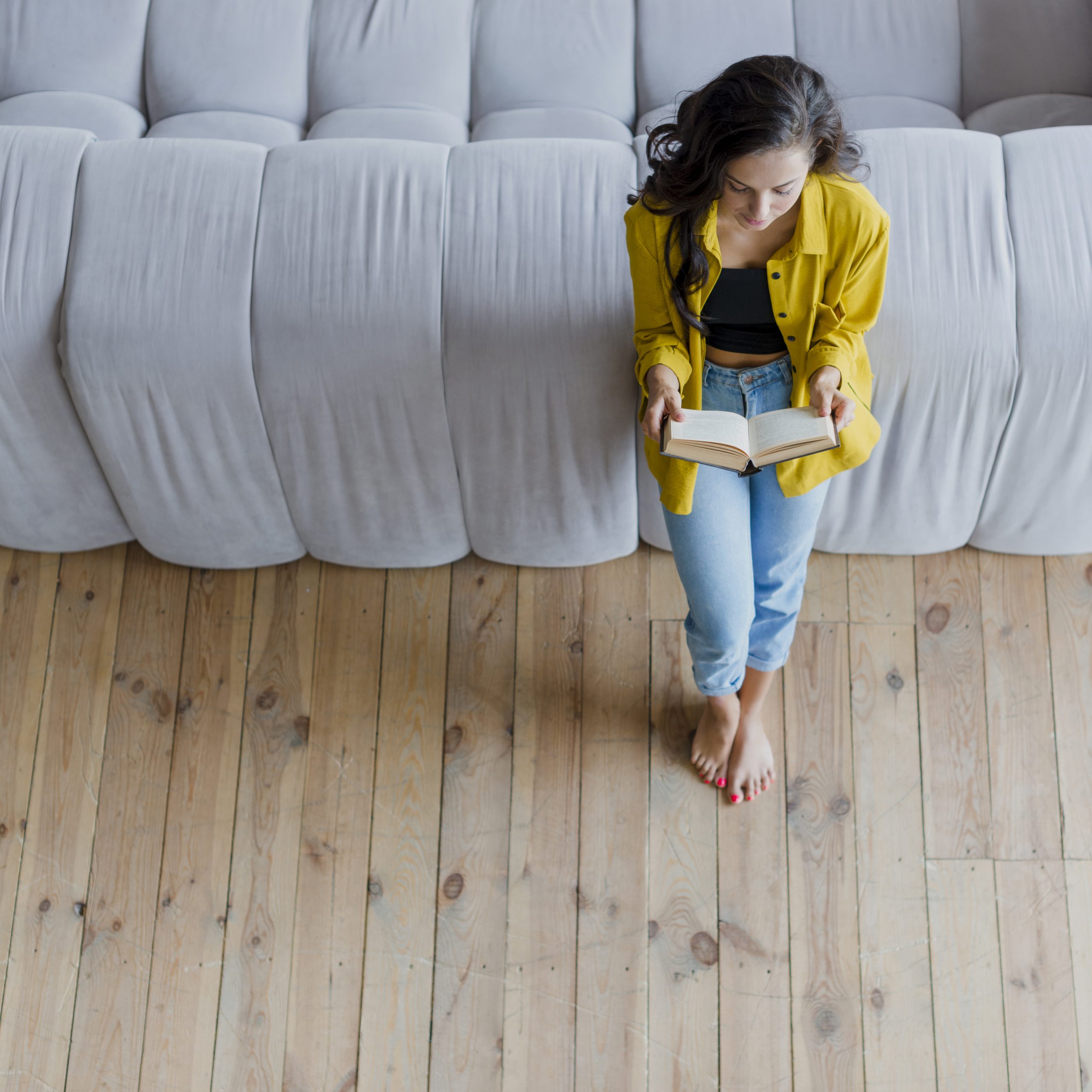 Girl reading comfortably at home in balanced Calgary indoor humidity