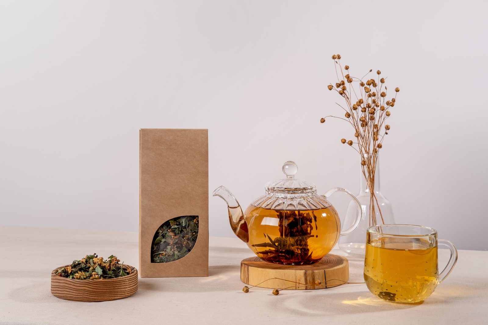 An artisanal tea selection, boxed, beside a steaming cup