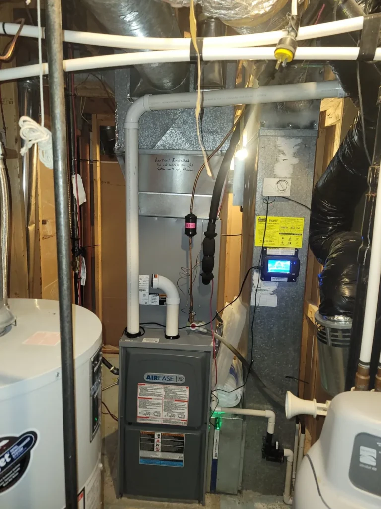 AirEase furnace and hot water tank installed in a Calgary basement mechanical room