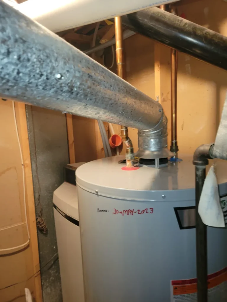 Gas hot water tank with new venting, installed in a Calgary basement