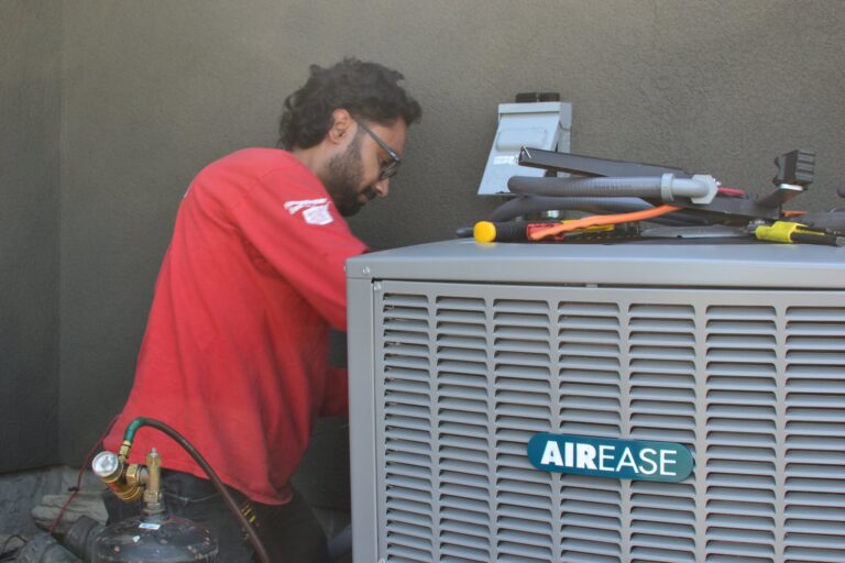 Technician servicing an air conditioner