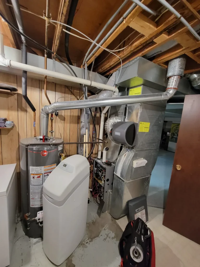 Calgary basement mechanical room with a new water heater, water softener and furnace