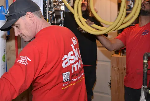 Wall-mounted tankless water heater professionally installed by Alberta Indoor Comfort