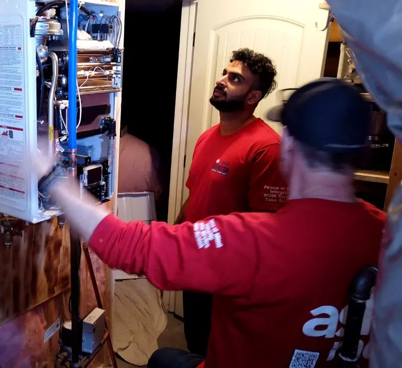 Close-up of tankless water heater installation and venting work