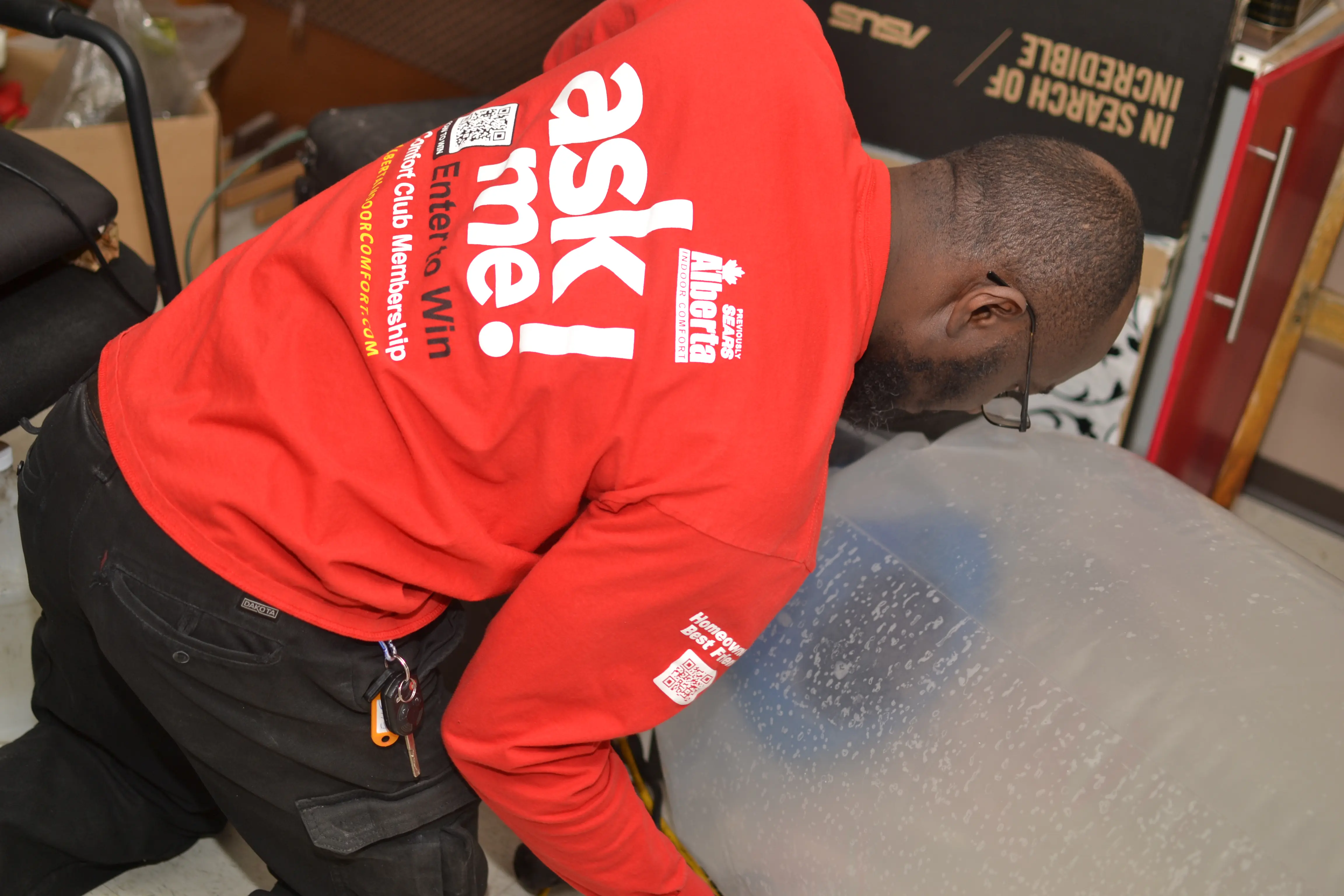 AIC technician running an Aeroseal duct-sealing service in a Calgary home AIC technician running an Aeroseal duct-sealing service in a Calgary home